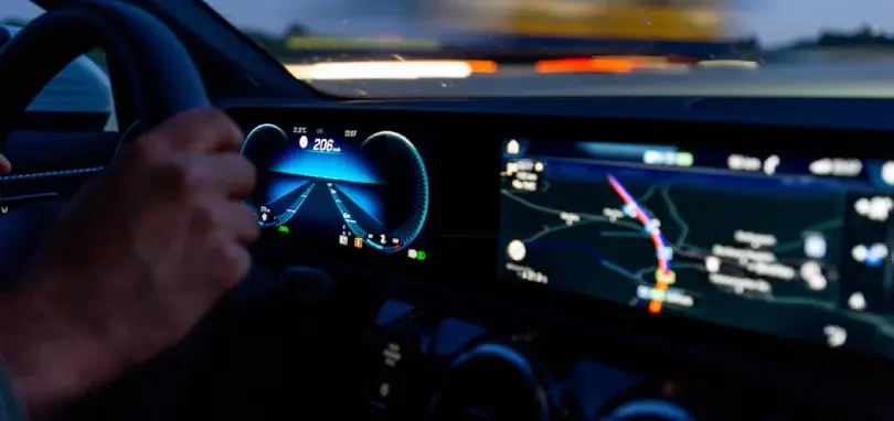 driving a car with the electronic dashboard visible