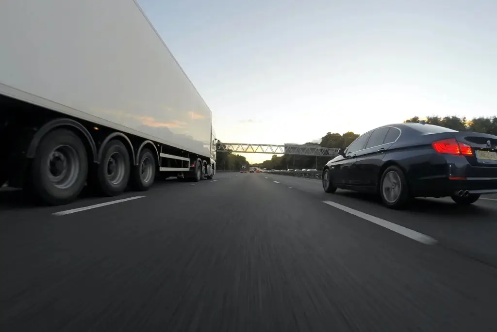 a semi truck and a car on a highway